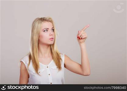advertisement concept. Woman pointing copy space empty blank on gray