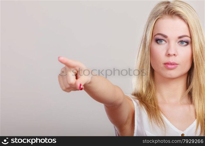 advertisement concept. Woman pointing copy space empty blank or pushing touch screen pressing digital virtual button on gray