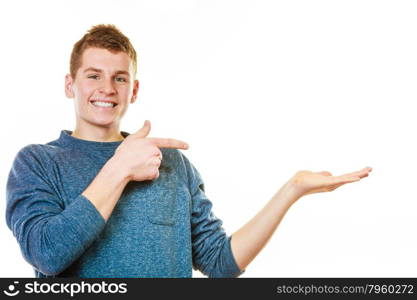 advertisement concept. Young man holding open palm empty hand showing copy space for product isolated on white background