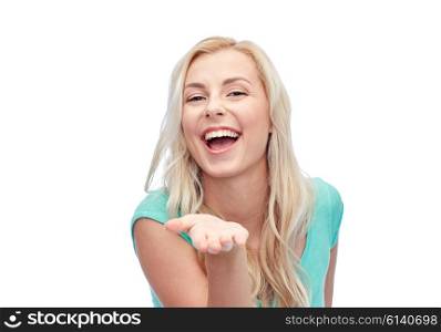 advertisement, emotions and people concept - smiling young woman or teenage girl holding something on hand