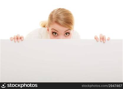 Advertisement. Funny woman hiding behind blank copy space banner isolated on white. Businesswoman recommending your product