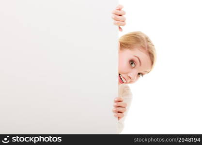 Advertisement. Funny woman hiding behind blank copy space banner isolated on white. Businesswoman recommending your product