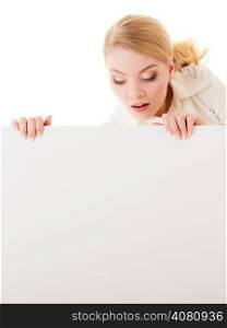 Advertisement. Funny woman hiding behind blank copy space banner isolated on white. Businesswoman recommending your product