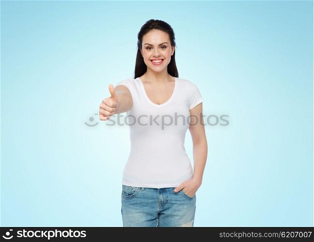 advertisement, gesture, clothing and people concept - happy smiling young woman or teenage girl in white t-shirt showing thumbs up over blue background