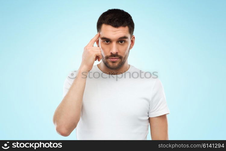 advertisement, idea, inspiration and people concept - man pointing finger to his temple over blue background