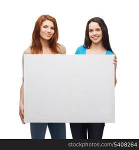 advertisement, sale and people concept - smiling young girls with blank white board