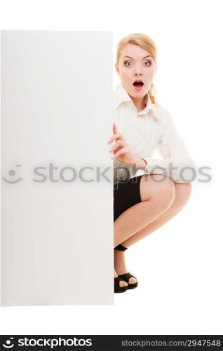 Advertisement. Surprised woman hiding behind blank copy space banner isolated on white. Businesswoman recommending your product