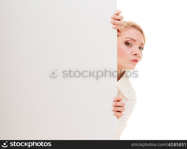 Advertisement. Worried woman hiding behind blank copy space banner isolated on white. Businesswoman recommending your product