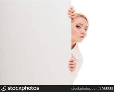 Advertisement. Worried woman hiding behind blank copy space banner isolated on white. Businesswoman recommending your product
