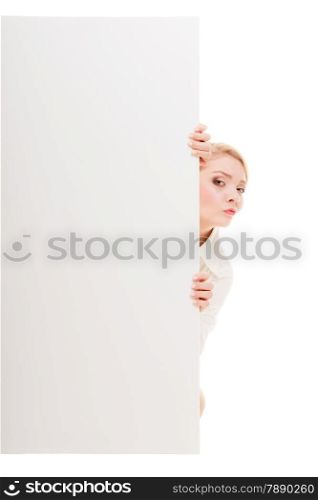 Advertisement. Worried woman hiding behind blank copy space banner isolated on white. Businesswoman recommending your product