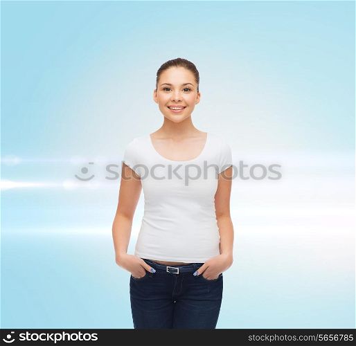 advertising and people concept - smiling young woman in blank white t-shirt over blue laser background