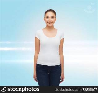 advertising and people concept - smiling young woman in blank white t-shirt over blue laser background