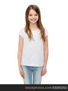 advertising and t-shirt design concept - smiling little girl in white blank t-shirt over white background