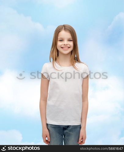 advertising and t-shirt design concept - smiling little girl in white blank t-shirt over white background