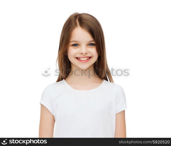 advertising and t-shirt design concept - smiling little girl in white blank t-shirt over white background. smiling little girl in white blank t-shirt