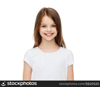 advertising and t-shirt design concept - smiling little girl in white blank t-shirt over white background. smiling little girl in white blank t-shirt