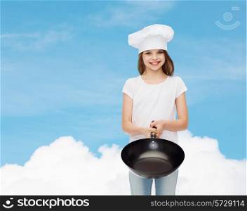 advertising, childhood, cooking and people - smiling girl in white t-shirt and cooking hat holding pan over blue sky background