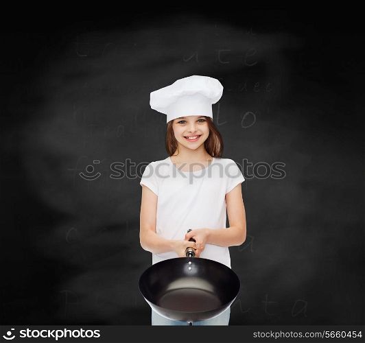 advertising, childhood, cooking, education and people - smiling girl in white t-shirt and cooking hat holding pan over blackboard background