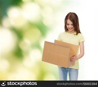 advertising, childhood, delivery, mail and people - smiling girl holding open cardboard box and looking into it over green background