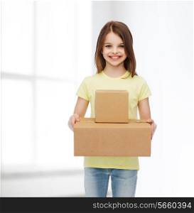 advertising, childhood, delivery, mail and people - smiling little girl holding cardboard boxes over white room background