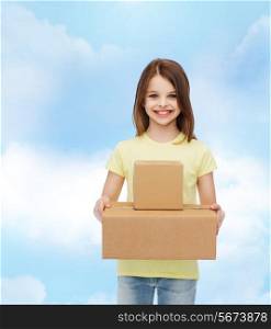advertising, childhood, delivery, mail and people - smiling little girl holding cardboard boxes over cloudy background