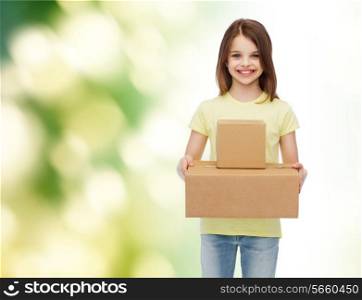 advertising, childhood, delivery, mail and people - smiling little girl holding cardboard boxes over green background