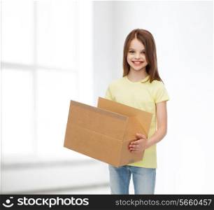 advertising, childhood, delivery, mail and people - smiling little girl holding open cardboard box over white room background