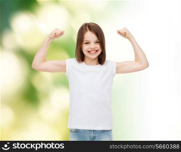 advertising, childhood, gesture, ecology and people - smiling little girl in white blank t-shirt with raised arms over green background