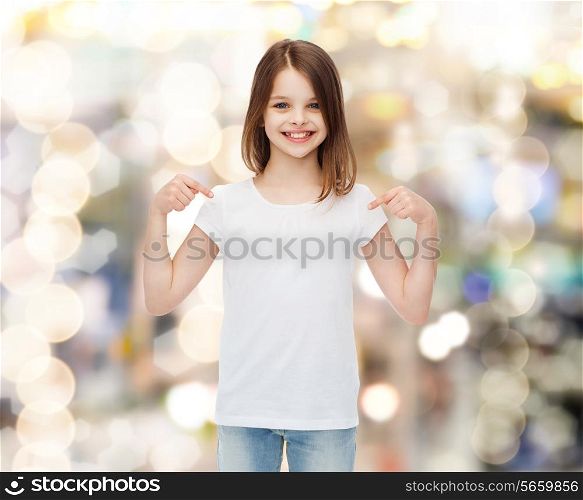 advertising, childhood, gesture, holidays and people - smiling girl in white t-shirt pointing fingers on herself over sparkling background