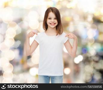 advertising, childhood, gesture, holidays and people - smiling girl in white t-shirt pointing fingers on herself over sparkling background