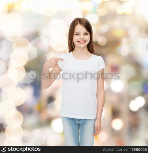 advertising, childhood, gesture, holidays and people - smiling girl in white t-shirt pointing finger on herself over sparkling background