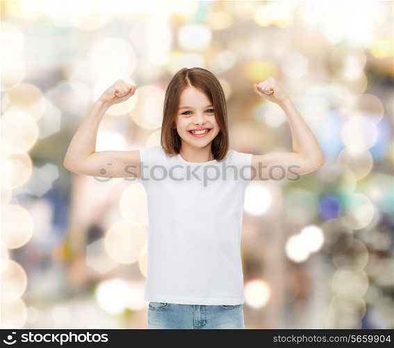 advertising, childhood, gesture, holidays and people - smiling little girl in white blank t-shirt with raised arms over sparkling background