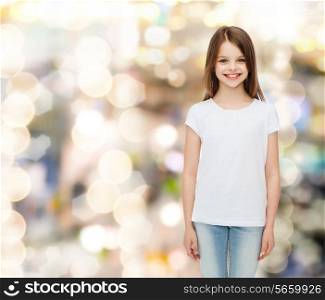 advertising, childhood, holidays and people - smiling little girl in white blank t-shirt over sparkling background