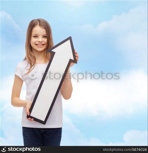 advertising, direction, air, aviation, and childhood concept - smiling little girl with white blank arrow pointing up over cloudy sky background
