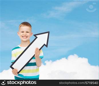 advertising, direction and childhood concept - smiling little boy with white blank arrow pointing up over blue sky