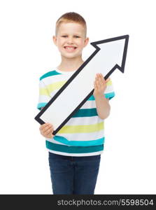 advertising, direction and childhood concept - smiling little boy with white blank arrow pointing up