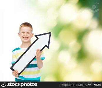 advertising, direction, ecology and childhood concept - smiling little boy with white blank arrow pointing up over green background
