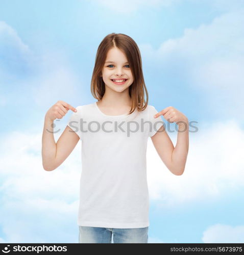 advertising, dream, childhood, gesture and people - smiling little girl in white t-shirt pointing fingers on herself over cloudy sky background