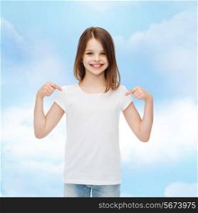 advertising, dream, childhood, gesture and people - smiling little girl in white t-shirt pointing fingers on herself over cloudy sky background