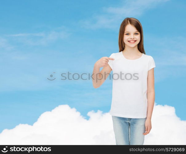 advertising, dream, childhood, gesture and people - smiling little girl in white t-shirt pointing finger on herself over blue sky background