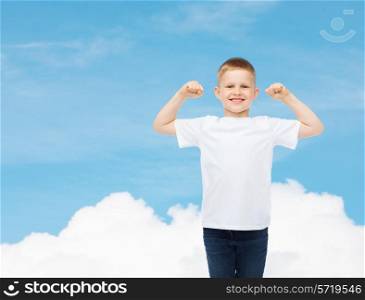 advertising, dream, people and childhood concept - smiling little boy in white blank t-shirt with raised hands over sky background
