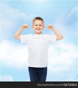 advertising, dream, people and childhood concept - smiling little boy in white blank t-shirt with raised hands over cloudy sky background