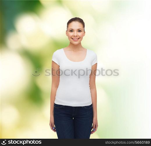 advertising, ecology and people concept - smiling young woman in blank white t-shirt over green background