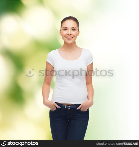 advertising, ecology and people concept - smiling young woman in blank white t-shirt over green background