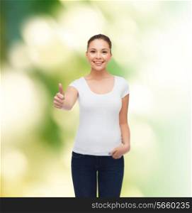 advertising, ecology, gesture and people concept - smiling young woman in blank white t-shirt showing thumbs up over green background