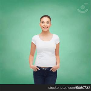advertising, education, school and people concept - smiling young woman in blank white t-shirt over green board background