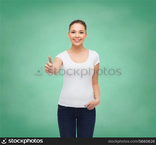 advertising, education, school, gesture and people concept - smiling young woman in blank white t-shirt showing thumbs up over green board background