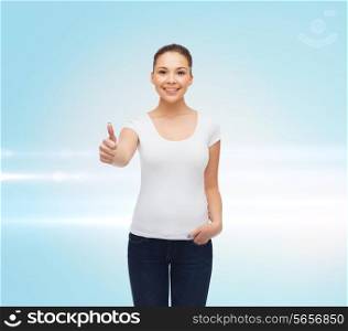 advertising, gesture and people concept - smiling young woman in blank white t-shirt showing thumbs up over blue laser background