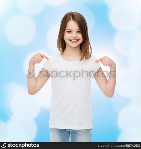 advertising, gesture, childhood and people - smiling little girl in white blank t-shirt pointing fingers on herself over blue background