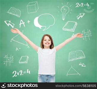 advertising, gesture, education, childhood and people - smiling girl in white t-shirt with stretched out arms over green board with doodles background